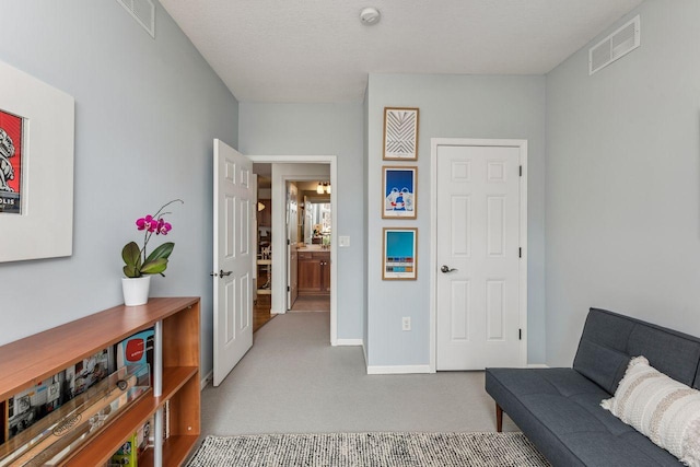 living area featuring light carpet