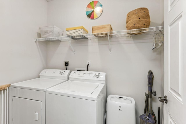 laundry area featuring washing machine and clothes dryer