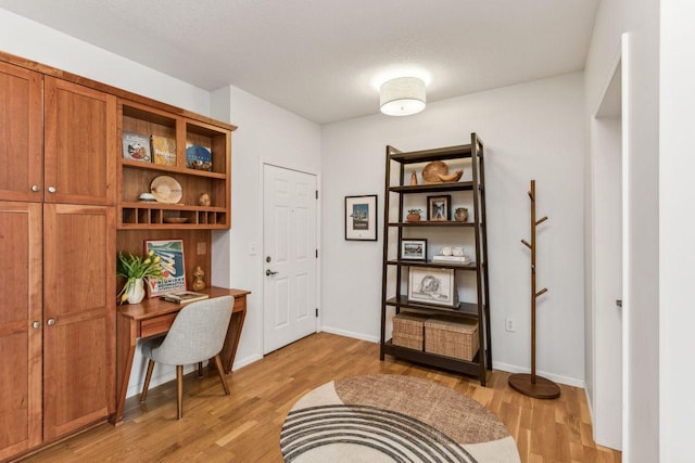 office featuring light hardwood / wood-style floors and a textured ceiling