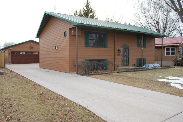 view of front of property with a garage and an outdoor structure