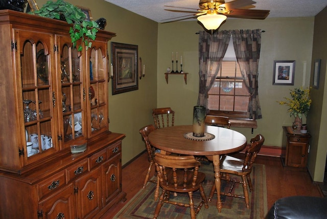 dining room with ceiling fan, dark hardwood / wood-style floors, and a textured ceiling