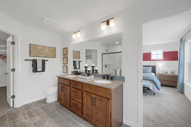 bathroom with vanity, toilet, and a shower with shower door