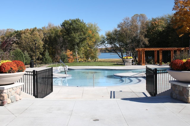 view of swimming pool with a water view and a patio