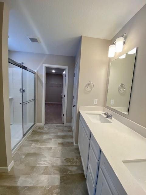 bathroom with vanity and an enclosed shower