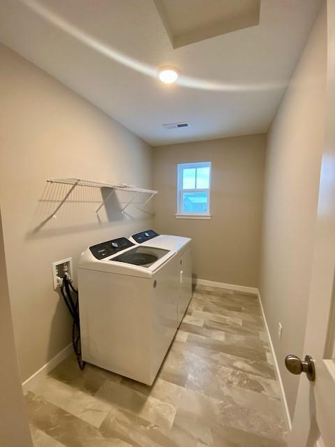 washroom featuring washer and clothes dryer