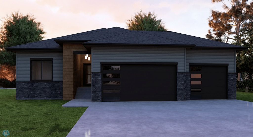 view of front facade featuring a garage and a lawn