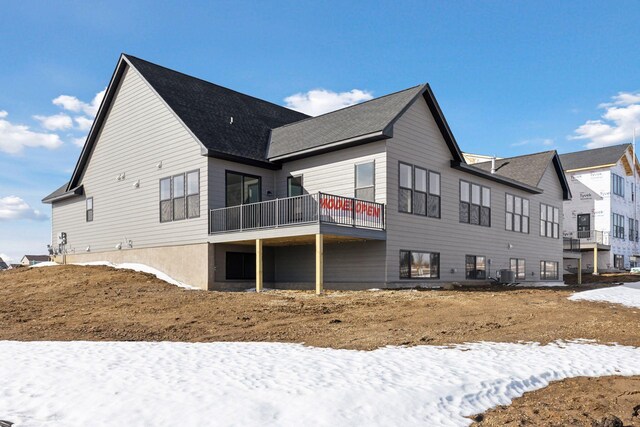 rear view of property featuring central AC unit