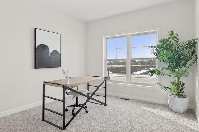 carpeted office with visible vents and baseboards