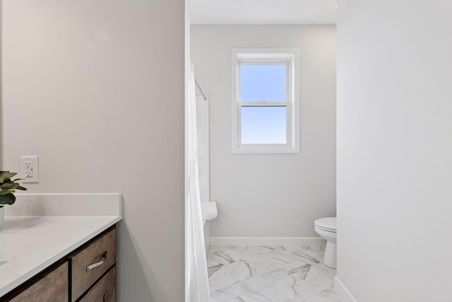 full bathroom featuring vanity, a shower with shower curtain, baseboards, toilet, and marble finish floor