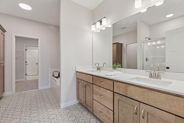 full bath with a sink, baseboards, a bath, and a shower stall