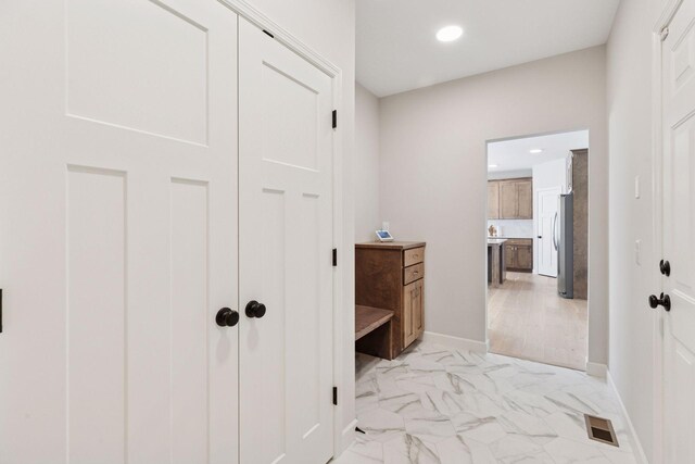 hall featuring recessed lighting, marble finish floor, visible vents, and baseboards