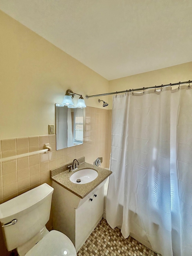 full bathroom featuring tile walls, vanity, toilet, shower / bath combo, and tile patterned floors