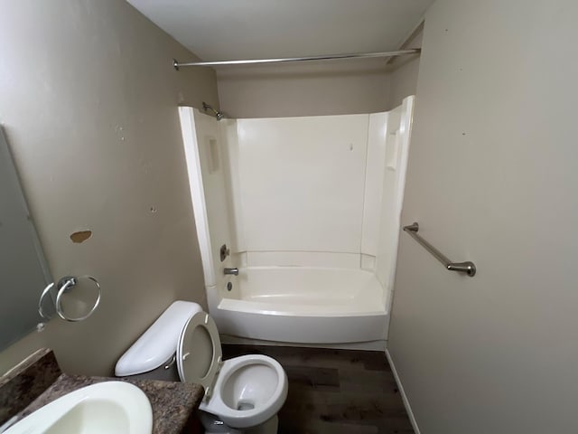 full bathroom with shower / bathing tub combination, hardwood / wood-style floors, vanity, and toilet