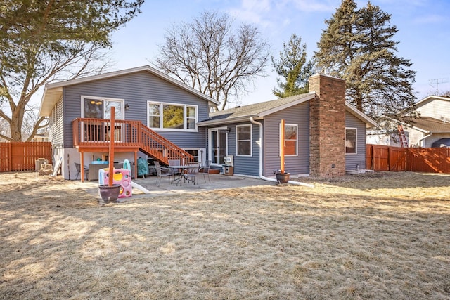 back of house featuring a chimney, fence, cooling unit, and a patio