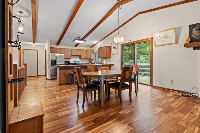 dining area featuring beam ceiling, an inviting chandelier, light hardwood / wood-style floors, and high vaulted ceiling