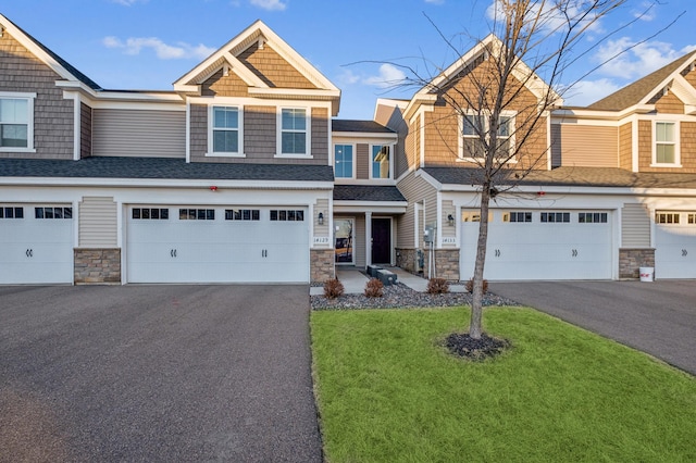 view of front of home with a garage and a front lawn