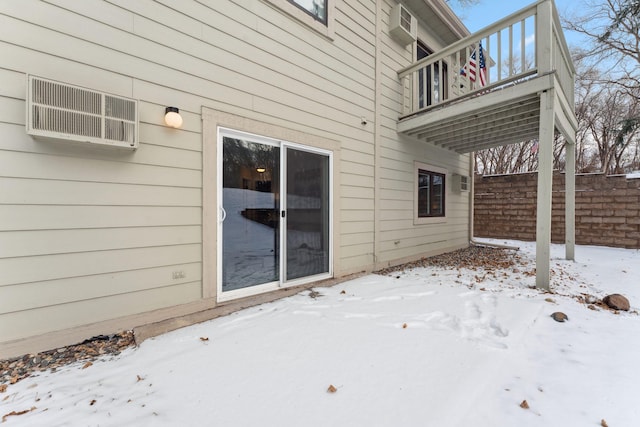 view of snow covered exterior with a balcony