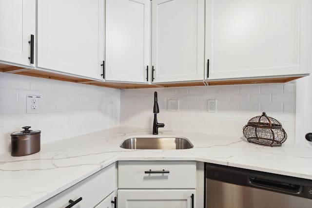 kitchen featuring white cabinetry, a sink, and stainless steel dishwasher