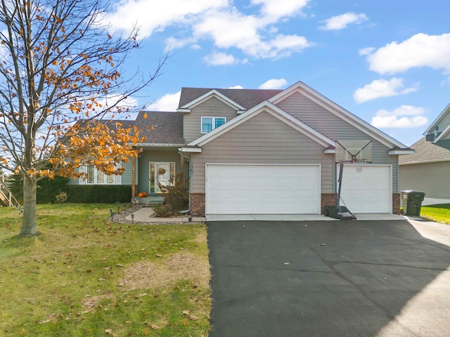 view of front of property with a front yard and a garage