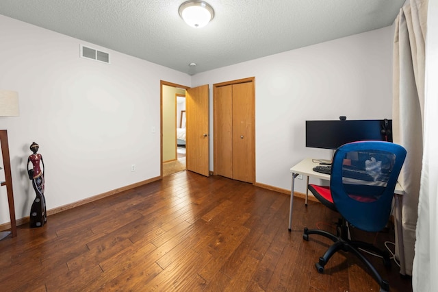 office space with a textured ceiling and dark hardwood / wood-style floors