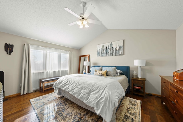 bedroom with dark hardwood / wood-style flooring, vaulted ceiling, and ceiling fan