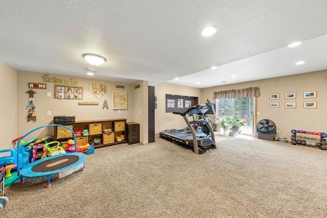 rec room with carpet flooring and a textured ceiling