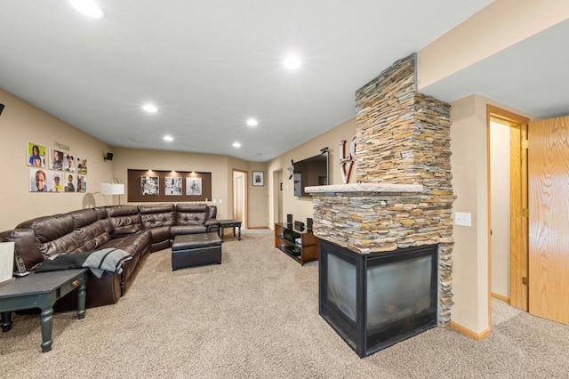 carpeted living room featuring a stone fireplace