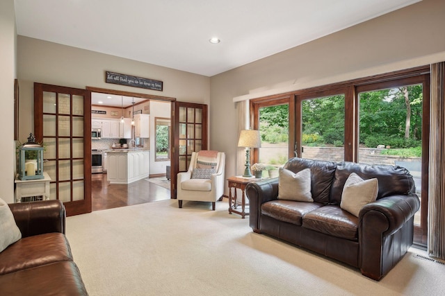 living room featuring carpet flooring and french doors