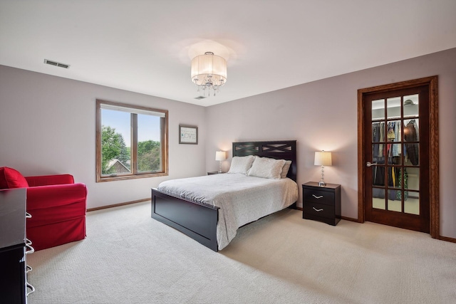 bedroom featuring carpet and a chandelier