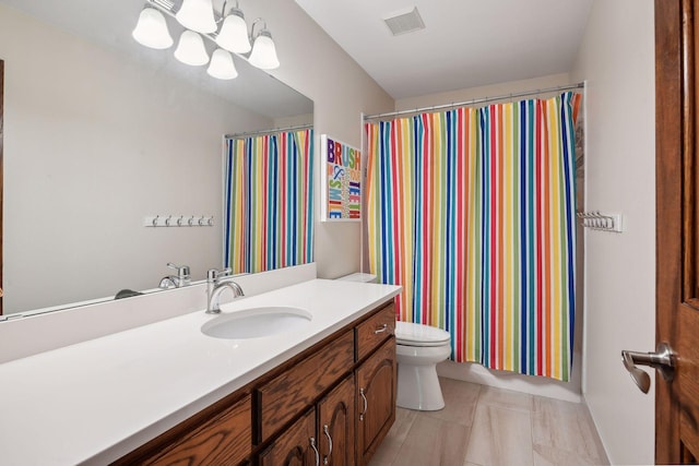 bathroom featuring tile patterned flooring, vanity, toilet, and curtained shower