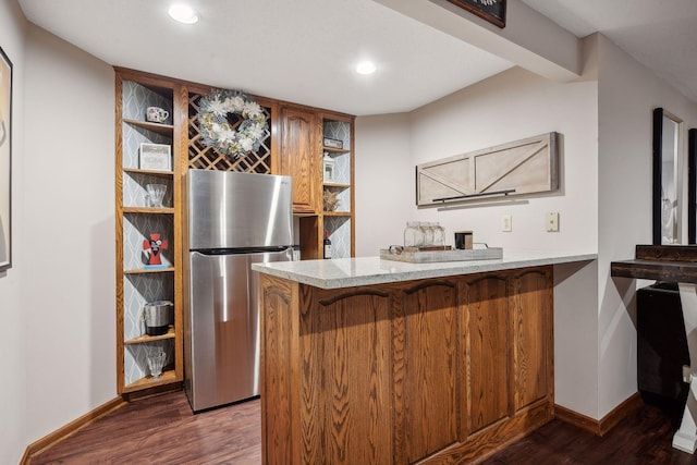 kitchen featuring kitchen peninsula, stainless steel fridge, and dark wood-type flooring