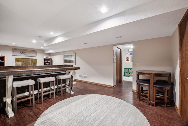 bar featuring dark hardwood / wood-style flooring