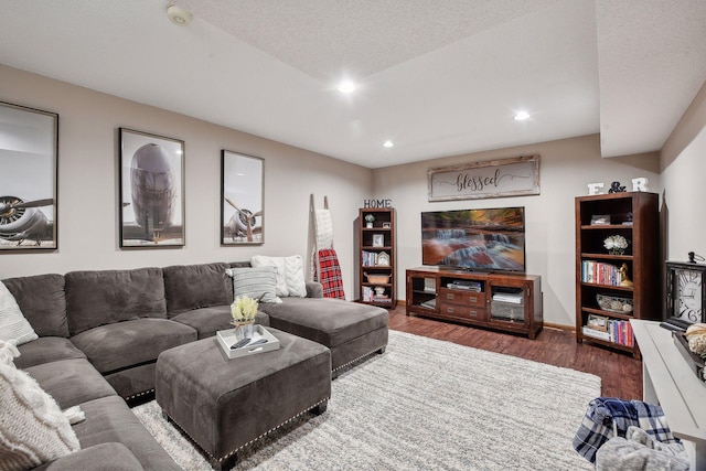 living room featuring a textured ceiling and dark hardwood / wood-style floors