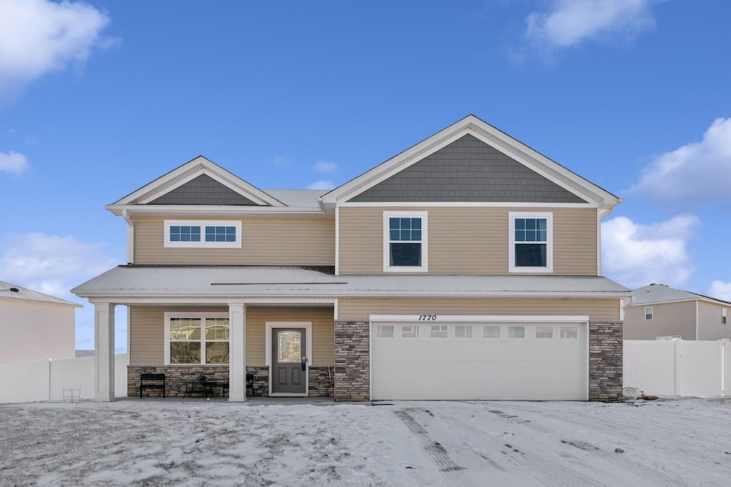 craftsman inspired home with a porch and a garage