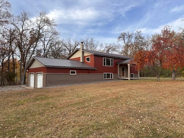 exterior space featuring a garage and a yard