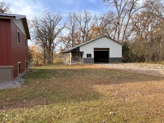 view of yard with a garage and an outdoor structure