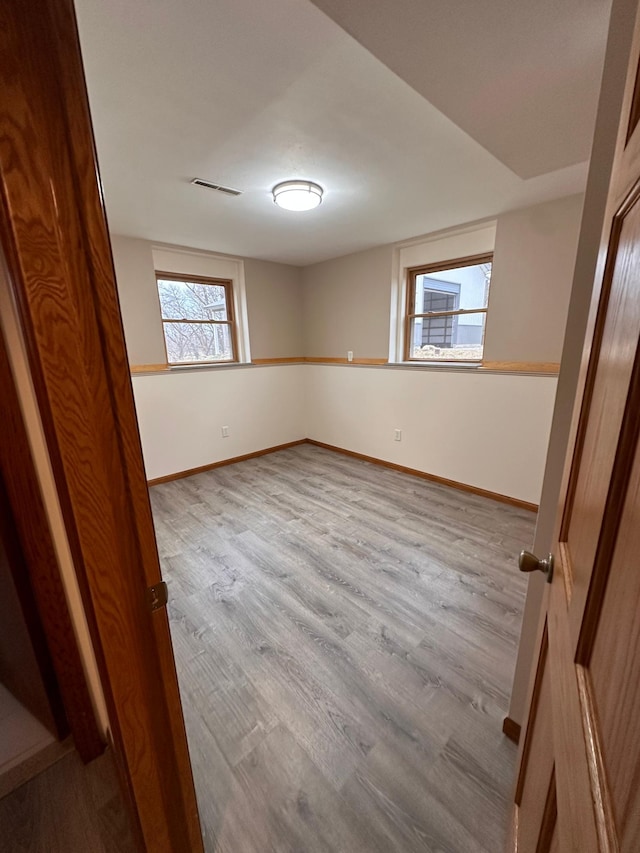 spare room featuring light wood-type flooring