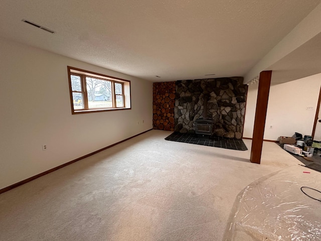 carpeted living room featuring a wood stove