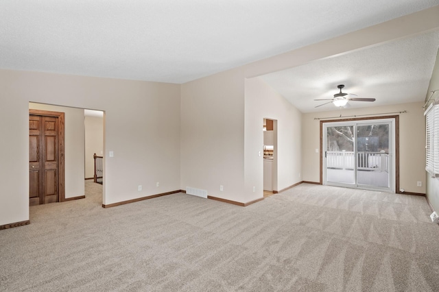 unfurnished living room with ceiling fan, light colored carpet, and vaulted ceiling