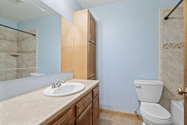 full bathroom with tile patterned floors, vanity, toilet, and tiled shower / bath combo