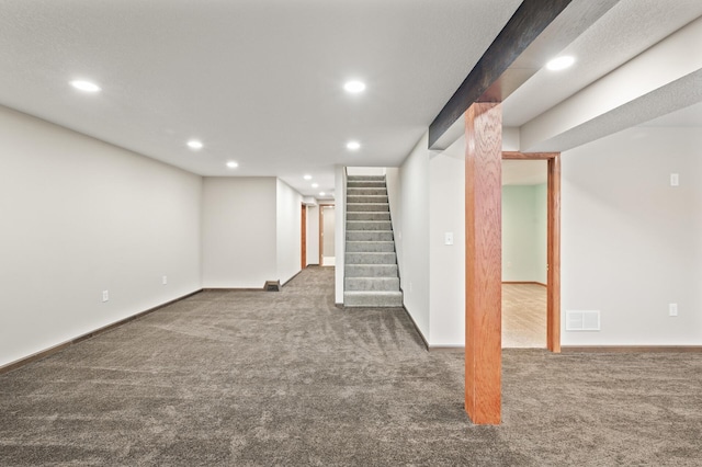 basement with dark colored carpet