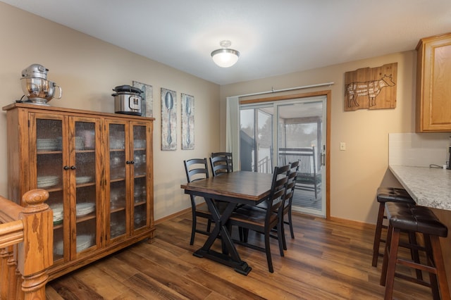 dining space with dark hardwood / wood-style floors