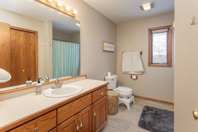 bathroom with toilet and vanity