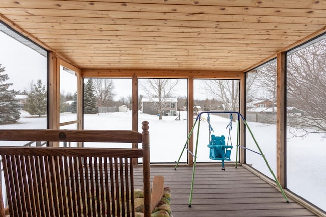 unfurnished sunroom featuring wood ceiling