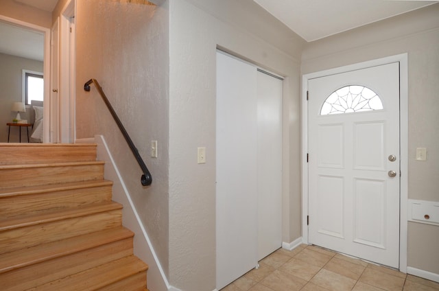 entryway with light tile patterned floors