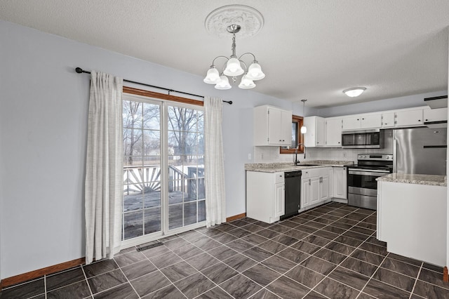 kitchen with sink, white cabinetry, stainless steel appliances, decorative light fixtures, and a chandelier