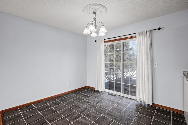 unfurnished room with an inviting chandelier and a textured ceiling