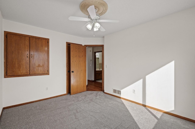 unfurnished bedroom with light colored carpet and ceiling fan