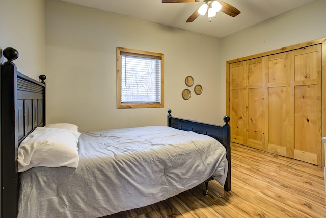 bedroom with ceiling fan, light hardwood / wood-style floors, and a closet