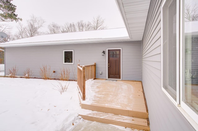 view of snow covered property entrance